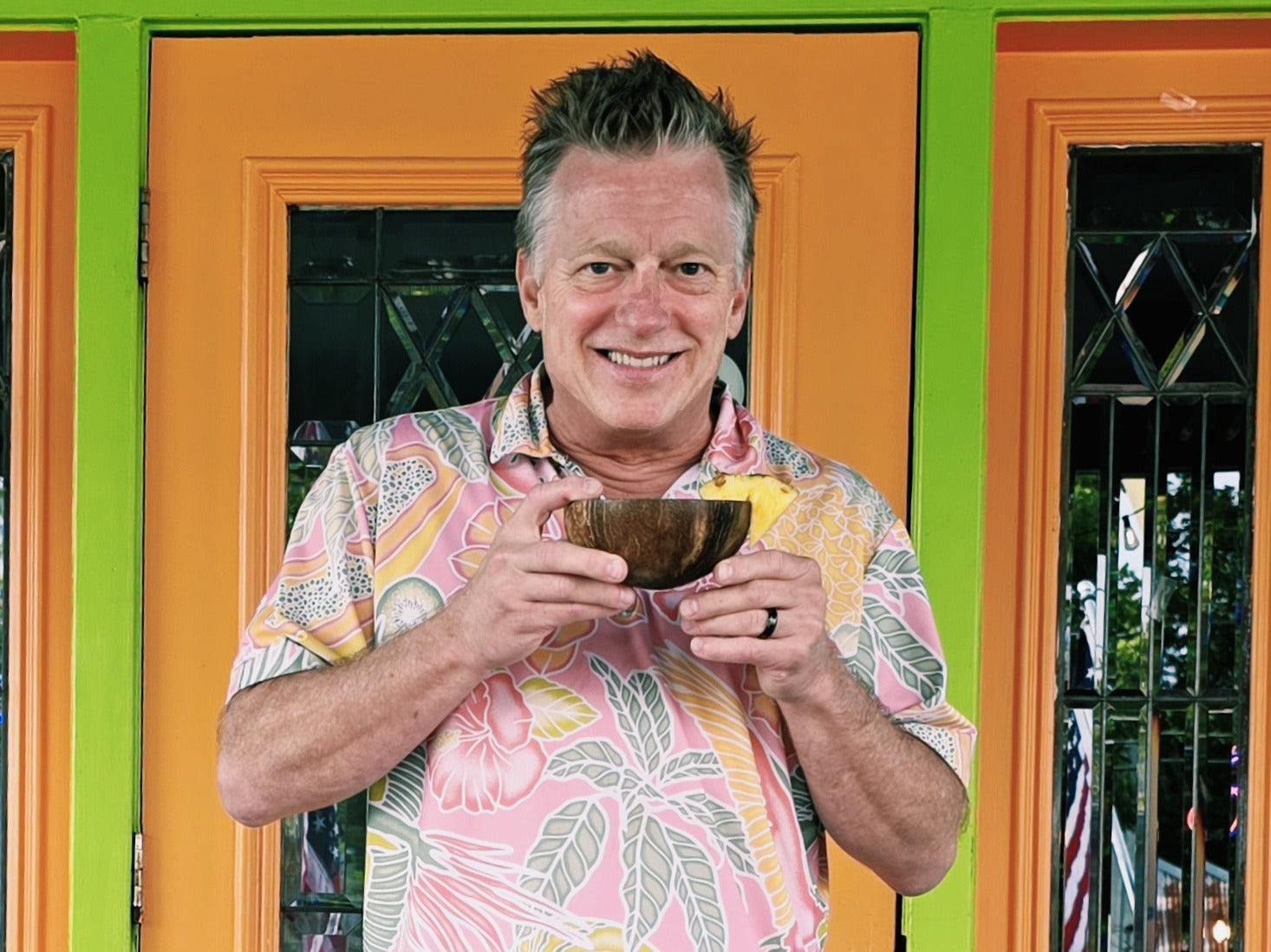 Owner Chris Jepson holding a kava shell outside Elixir Lounge Kava Bar